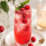Refreshing Raspberry Sparkler mocktail with fresh raspberries