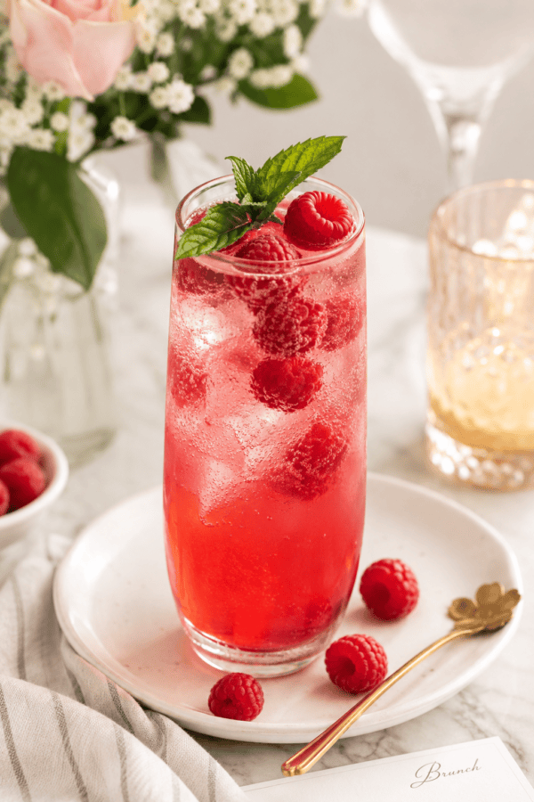 Refreshing Raspberry Sparkler mocktail with fresh raspberries